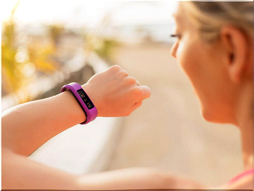 Woman wearing fitness bracelet to motivate herself to exercise again.