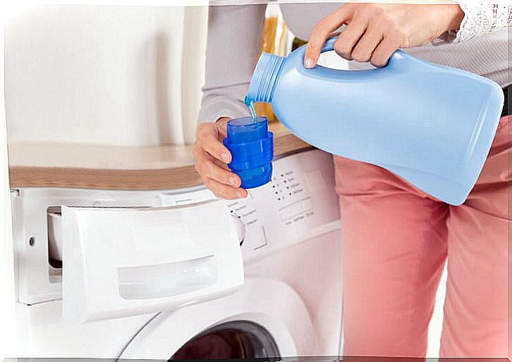 Woman pouring detergent into the washing machine