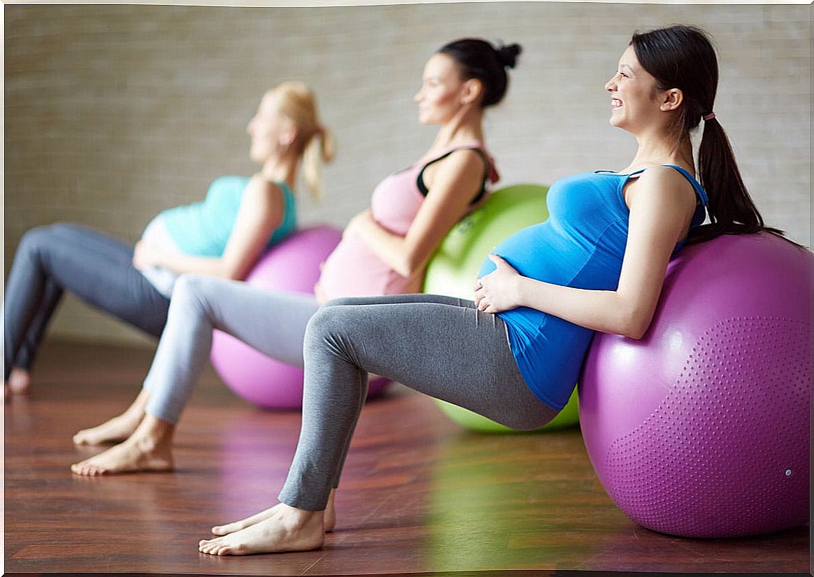 Pregnant women doing sports with the ball.