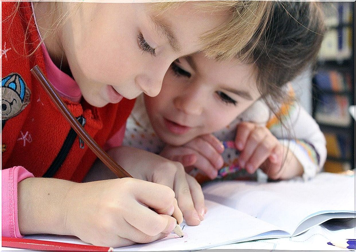 Children drawing with a pencil-