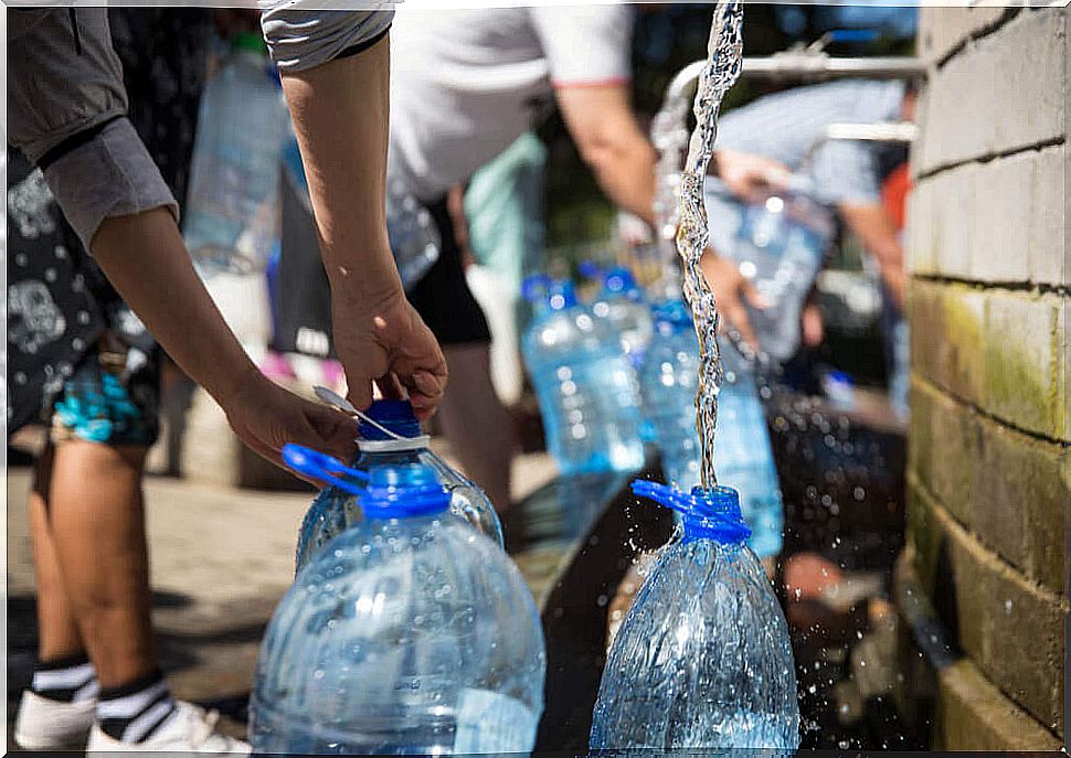 People filling plastic bottles.