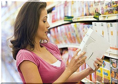 Woman reading a product label in the supermarket