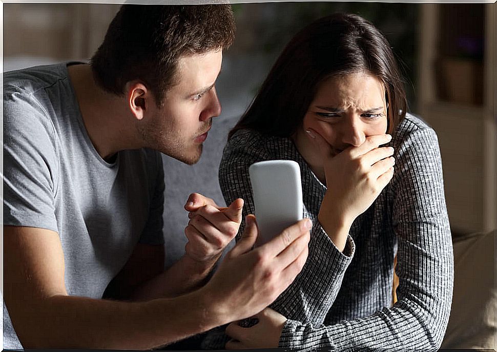 Jealous man showing a phone to his wife