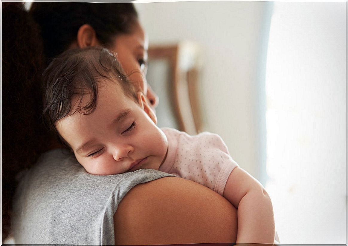 Mother walks a baby to sleep.